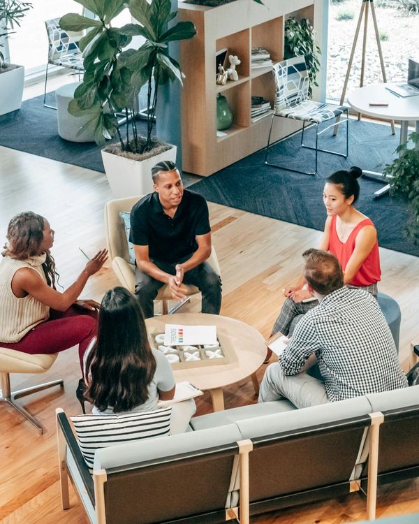 Team of diverse office workers looking focused and positive during a meeting.