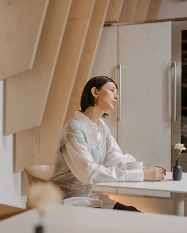 Woman in a calm state in a modern office, symbolizing peace and focus.